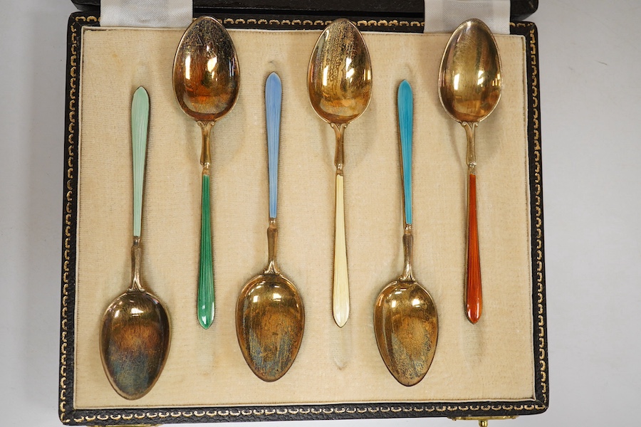 A cased set of six early 1950's silver gilt and polychrome enamel coffee spoons by Suckling Ltd (enamel a.f.). Condition - poor to fair